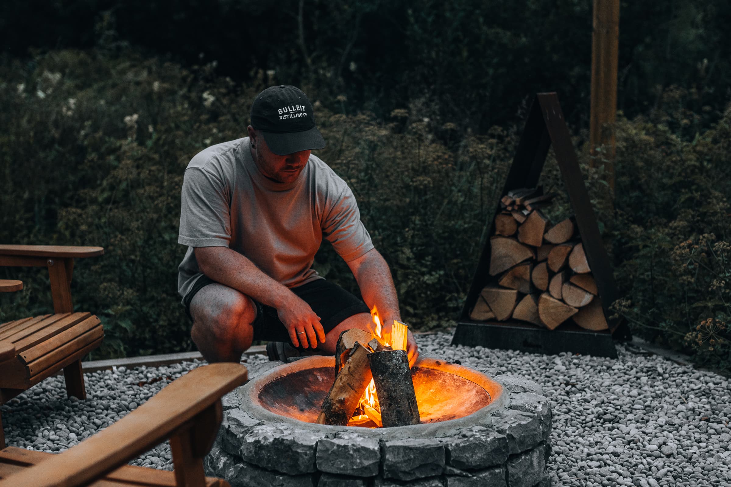 Outdoor fire pit gathering area with lake view